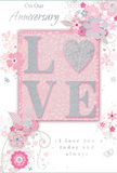 In this image, a tender and romantic anniversary card unfurls a story of enduring love, its design as carefully balanced as a bouquet arranged for delivery across Bermondsey. At the centre, the word LOVE rises up from the surface in raised, glitter-soft letters, each edge catching the light with a gentle sparkle. The letter O is beautifully transformed into a textured silver heart, shimmering with tiny reflective flecks that suggest both strength and delicacy, much like a long-lasting relationship. Surrounding this central emblem, delicate blooms painted in blush pinks and soft mauves appear to unfurl across the card in a soothing, watercolour style. Their petals and fine stems arc and swirl gracefully, echoing the movement of foliage in a carefully wired floral design. Subtle lines of silvery grey and pearly white add depth, highlighting details that feel refined and modern, reminiscent of stylish Bermondsey loft interiors. Tiny flourishes-curled tendrils, scattered petals, and whispered outlines of butterflies-add a sense of motion and quiet joy, like petals drifting across a table in a café off Bermondsey Street. Above and below the floral motif, the words On Our Anniversary and I love you today and always are written in an elegant, flowing script, their curves harmonising with the surrounding vines and flowers. Overall, the card conveys a sense of cherished intimacy: a soft yet striking keepsake that marks a shared journey with sincerity, as thoughtfully composed as a bespoke anniversary bouquet delivered to a loved one near London Bridge.